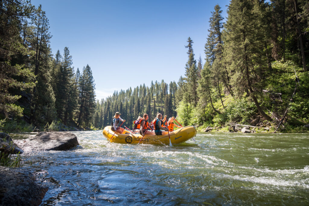 Scenic whitewater rafting tour with blue skies and calm water on the north fork of the payette in Idaho