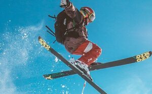 Pro Skier hitting a mute grab under blue skies