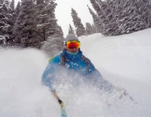 Skier getting face shots of deep powder from a ski run at Tamarack Resort in Idaho