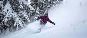 Snowboarder making big powder turns at Tamarack Resort in Idaho