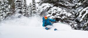 Adult skier makes big powder turns at Tamarack Resort in Idaho